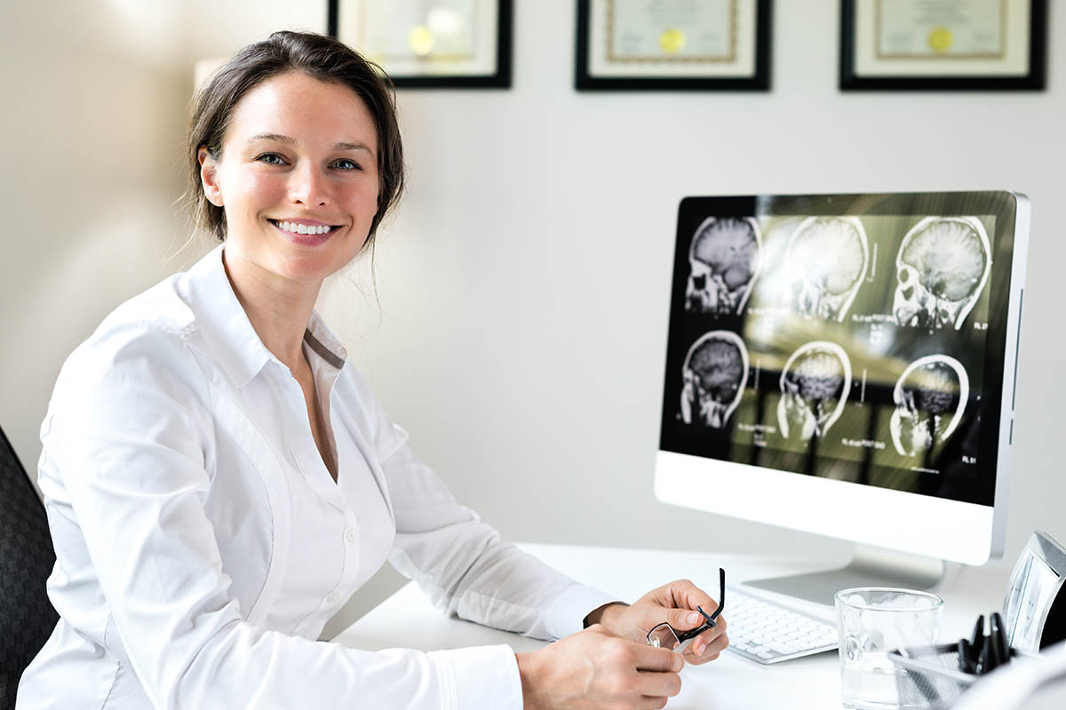 a doctor posing with a lot of graphs of the brain, understanding how benzos and the brain affect each other