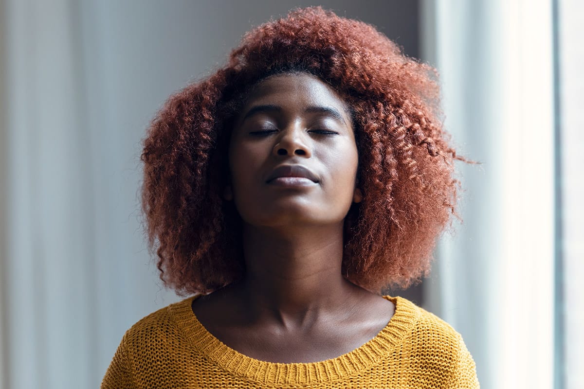 a person does a breathing exercises to manage anxiety symptoms