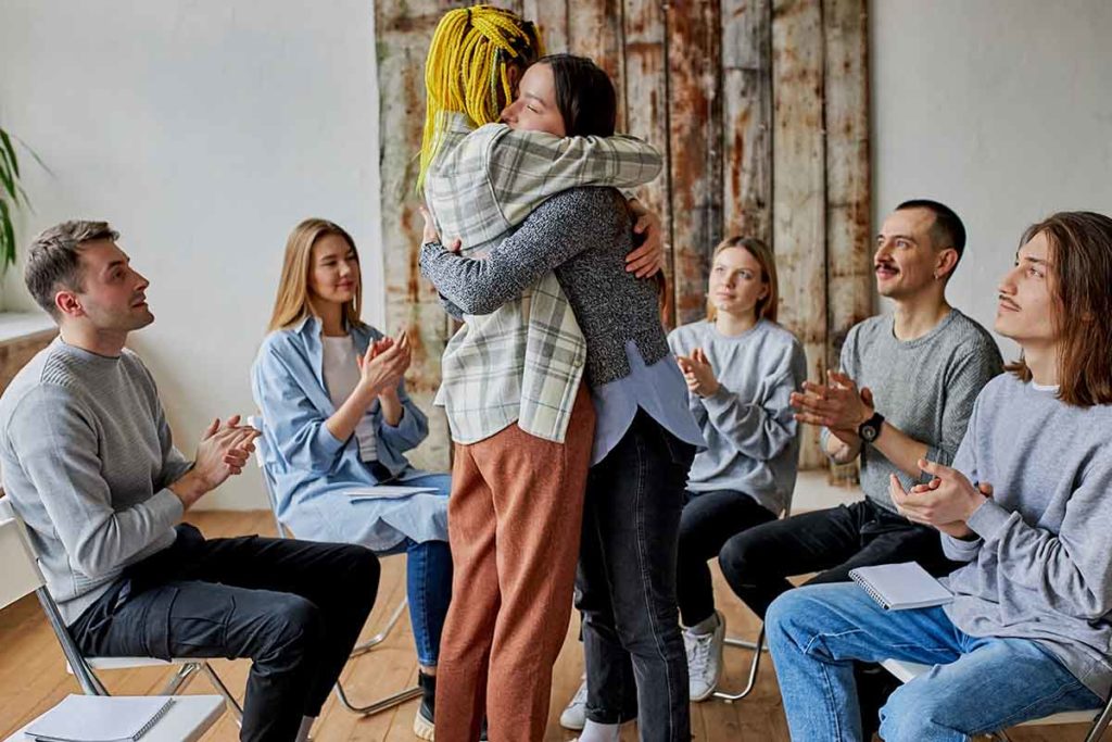 people hug in an lgbtq-friendly rehab in massachusetts