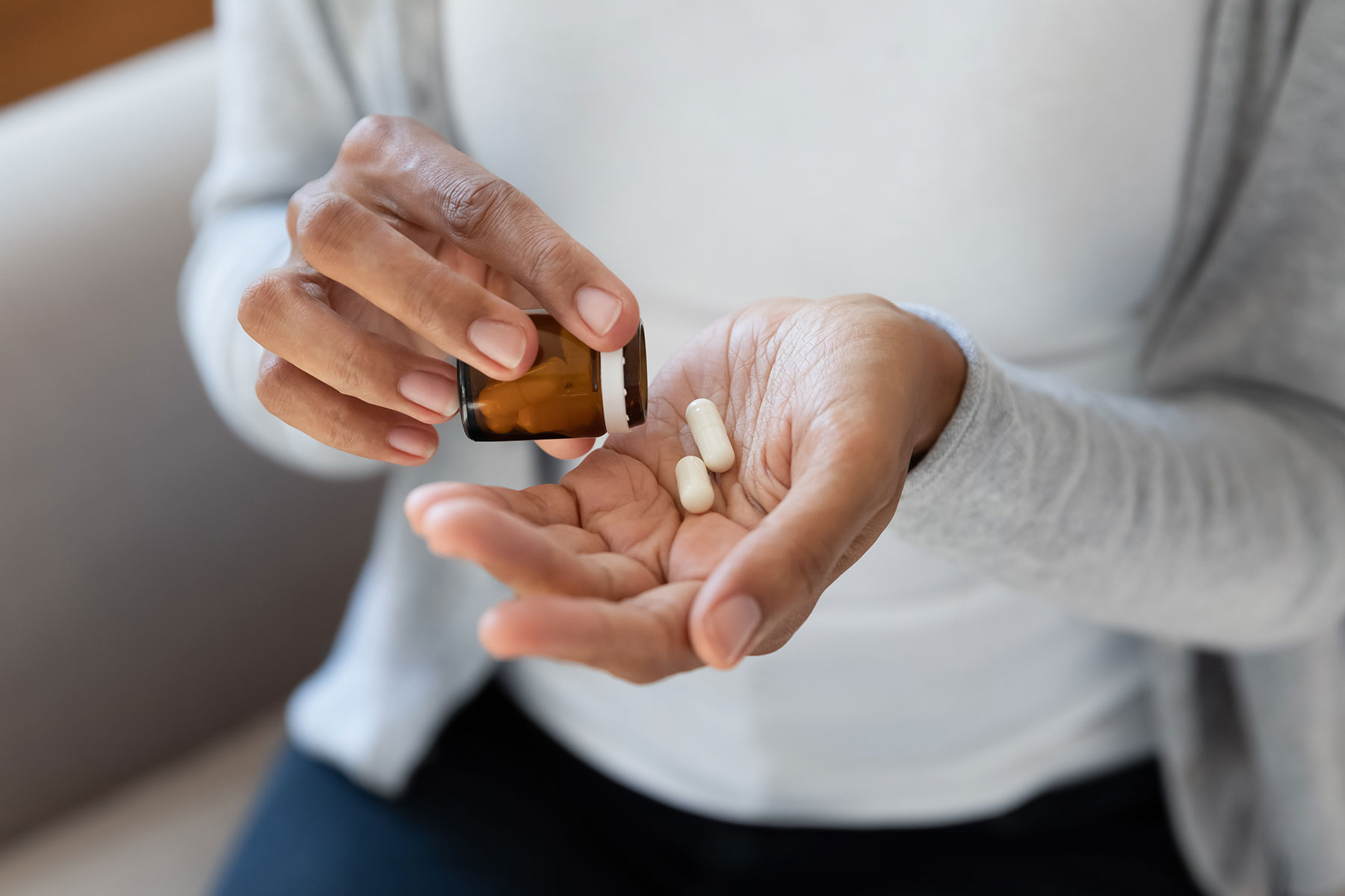 a person counts out pills from a bottle to show types of benzos