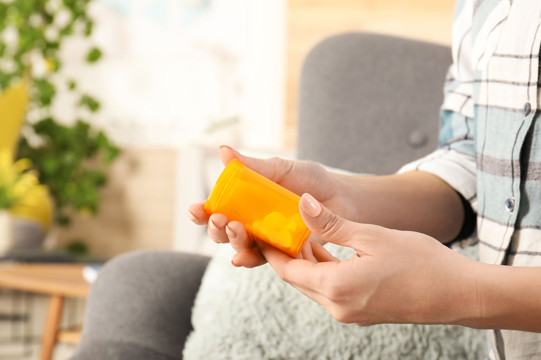 a person looks at a pill bottle to show benzo abuse