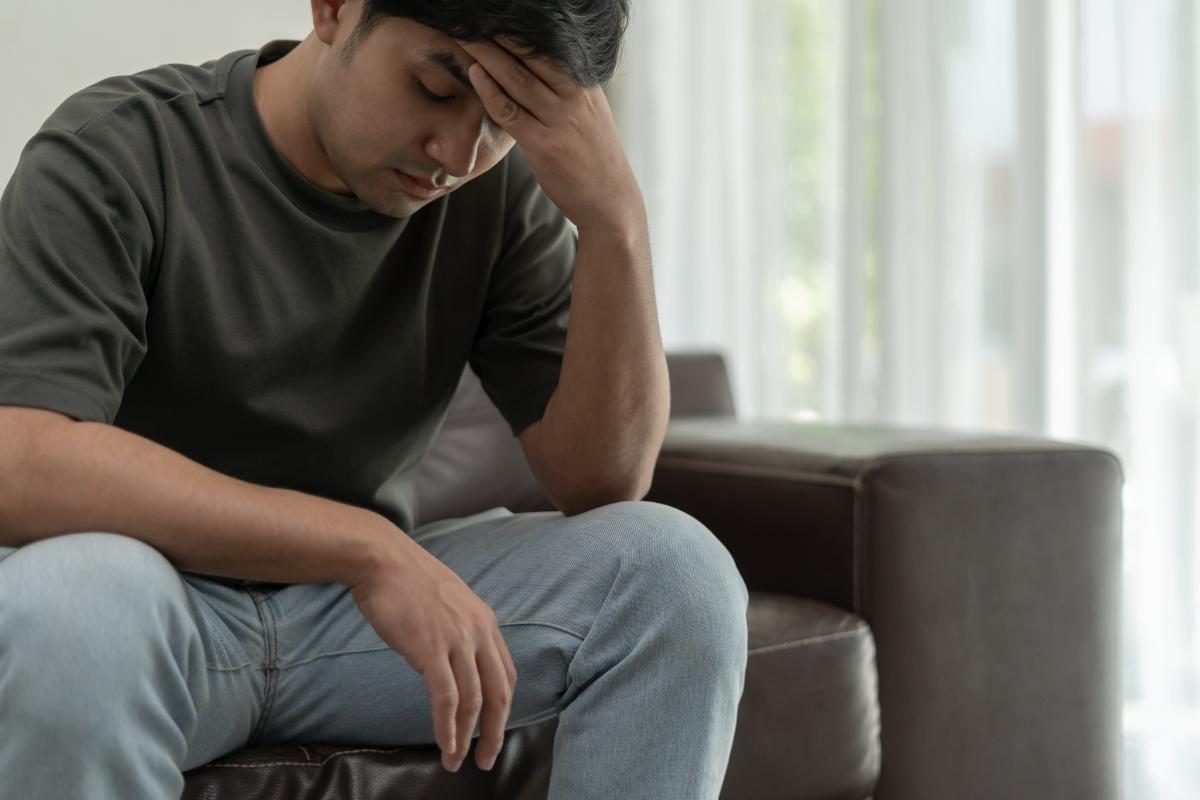 a person puts his hand on his forehead wondering about meth addiction