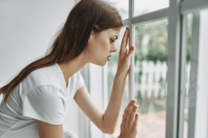 a person leans against a window and wonders about gabapentin and alcohol