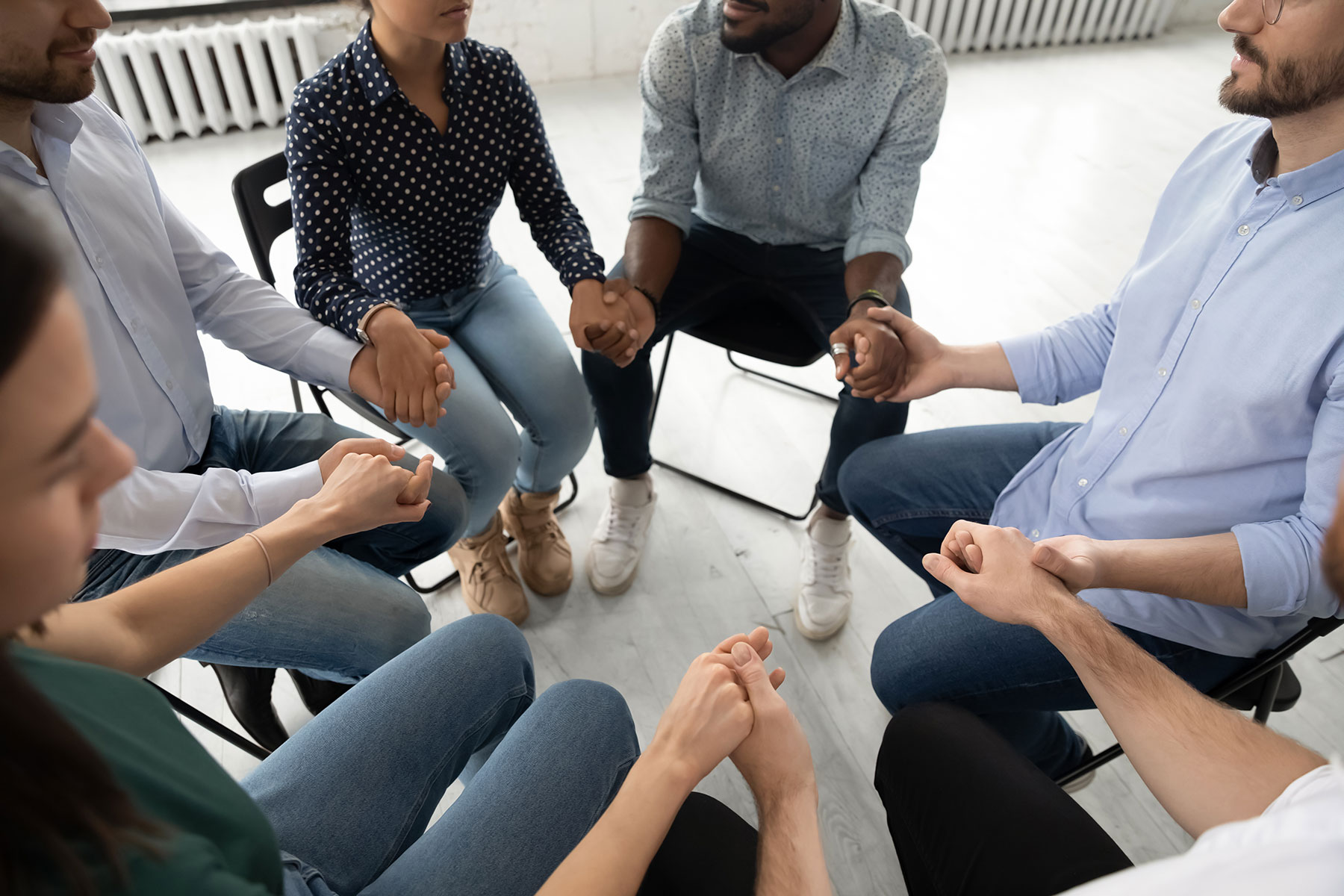 a group of people sit in a circle during outpatient treatment