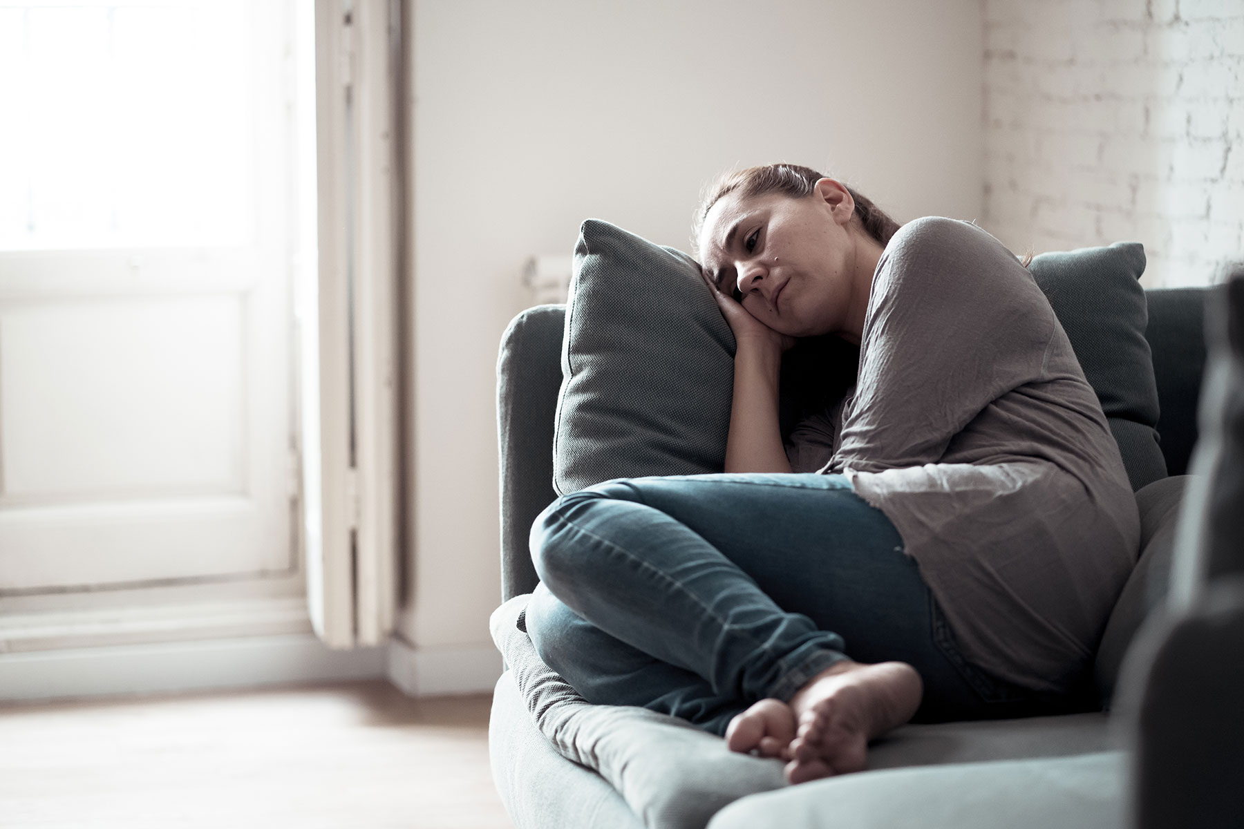 a person sleeps on a couch as they battle with heroin and depression