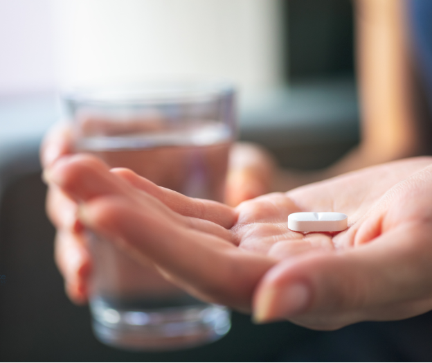 Person holds a Xanax pill in their hand